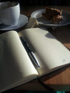 notebook open with cup of tea